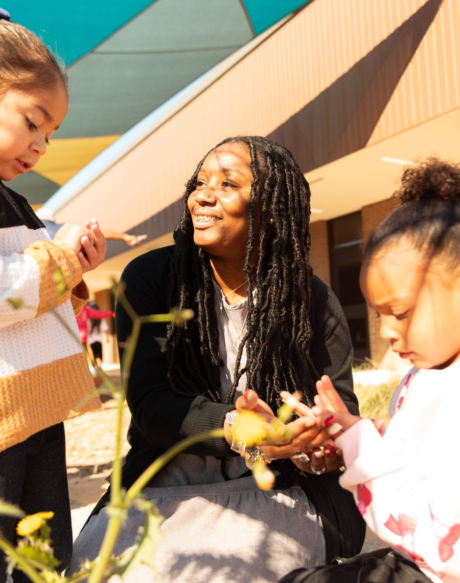 A Pre-K 4 SA educator outdoors with two children